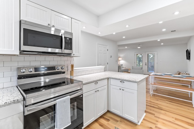 43 Summer Haven Trl Unit 3, Miramar Beach, FL 32550 - kitchen featuring appliances with stainless steel finishes, white cabinetry, a peninsula, backsplash, and recessed lighting