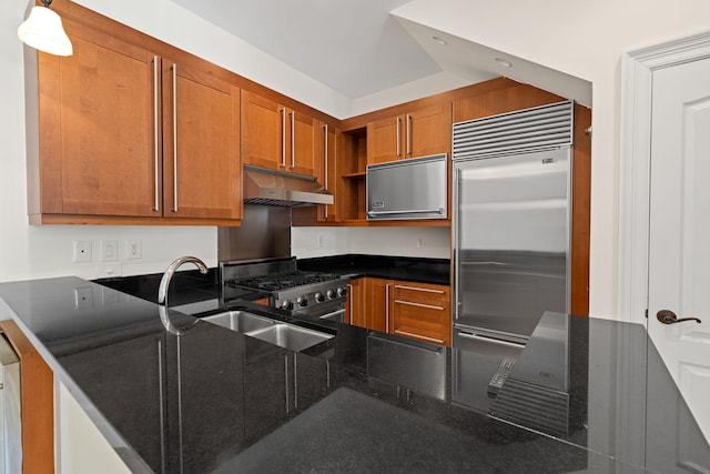 9201 Market St Inn Unit 159, Miramar Beach, FL 32550 - kitchen featuring under cabinet range hood, stainless steel appliances, brown cabinetry, open shelves, and dark stone counters