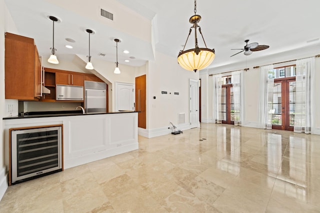 9201 Market St Inn Unit 159, Miramar Beach, FL 32550 - kitchen featuring beverage cooler, built in fridge, dark countertops, ceiling fan, and brown cabinetry