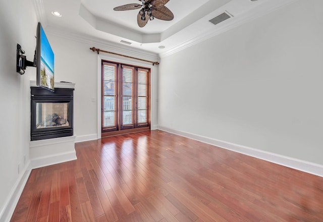 9201 Market St Inn Unit 159, Miramar Beach, FL 32550 - unfurnished living room featuring plenty of natural light, ceiling fan, a multi sided fireplace, wood finished floors, and ornamental molding