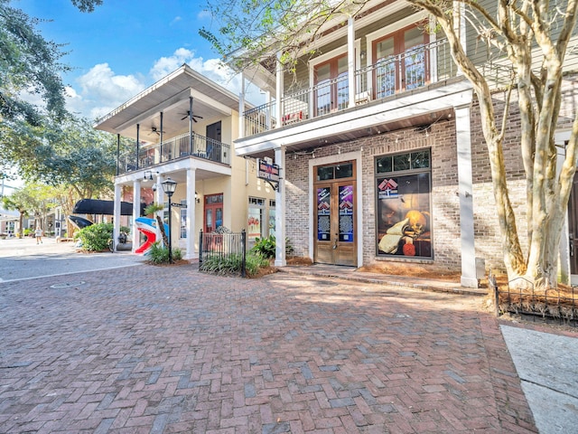 9201 Market St Inn Unit 159, Miramar Beach, FL 32550 - view of front of house with brick siding, a balcony, french doors, and ceiling fan
