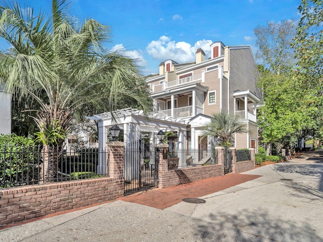 9201 Market St Inn Unit 159, Miramar Beach, FL 32550 - view of front of property featuring a balcony, a fenced front yard, and a gate