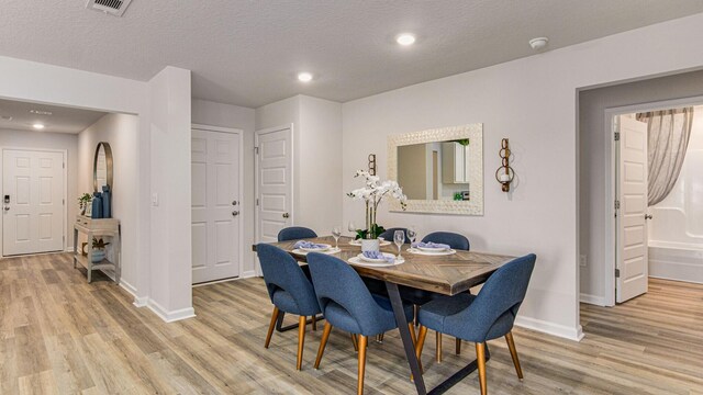 3064 Heritage Plantation Blvd, Laurel Hill, FL 32567 - dining space featuring light wood finished floors, baseboards, a textured ceiling, and recessed lighting