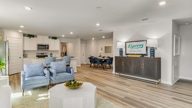 3064 Heritage Plantation Blvd, Laurel Hill, FL 32567 - living room with light wood finished floors, baseboards, and recessed lighting