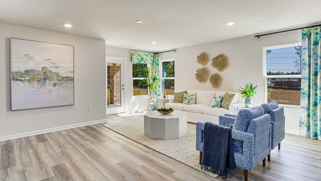 3064 Heritage Plantation Blvd, Laurel Hill, FL 32567 - living area with wood finished floors, recessed lighting, a textured ceiling, and baseboards