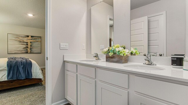 3064 Heritage Plantation Blvd, Laurel Hill, FL 32567 - ensuite bathroom with double vanity and a textured ceiling