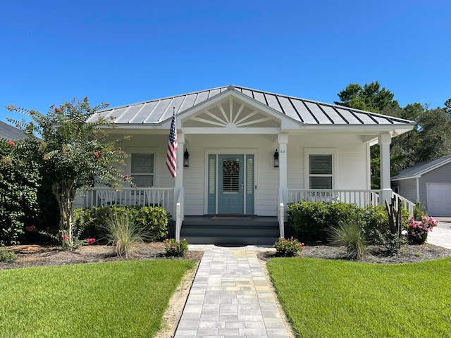 64 Spotted Dolphin Rd, Santa Rosa Beach, FL 32459 - bungalow-style house with a standing seam roof, covered porch, and metal roof
