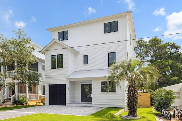 55 May Dr, Santa Rosa Beach, FL 32459 - view of front of home featuring an attached garage, decorative driveway, and a front lawn