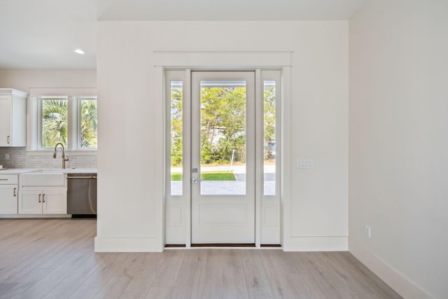 55 May Dr, Santa Rosa Beach, FL 32459 - doorway to outside with light wood-type flooring, plenty of natural light, a sink, baseboards, and recessed lighting