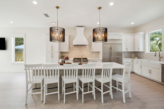 55 May Dr, Santa Rosa Beach, FL 32459 - kitchen with premium range hood, appliances with stainless steel finishes, light countertops, decorative backsplash, and recessed lighting