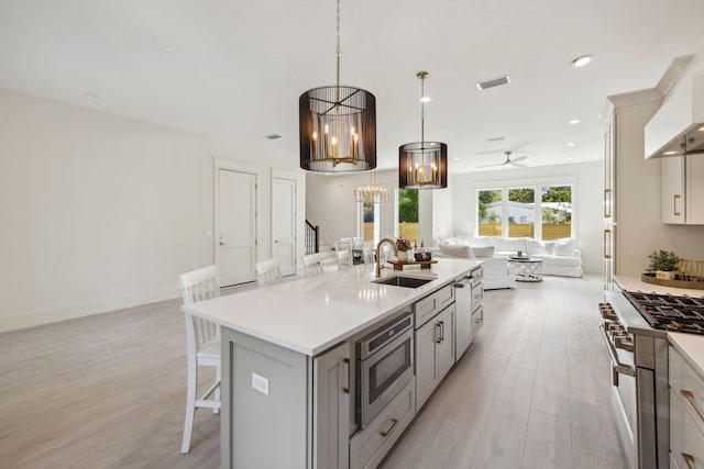 55 May Dr, Santa Rosa Beach, FL 32459 - kitchen with a sink, open floor plan, stainless steel appliances, light countertops, and ceiling fan