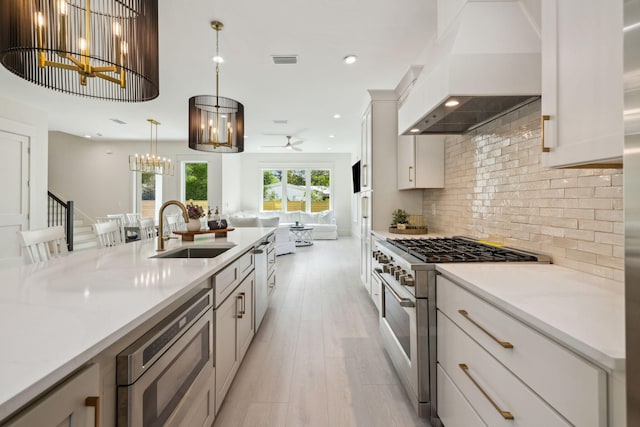 55 May Dr, Santa Rosa Beach, FL 32459 - kitchen with stainless steel appliances, a sink, custom exhaust hood, a chandelier, and ceiling fan