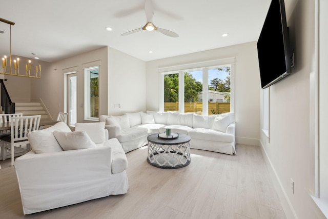 55 May Dr, Santa Rosa Beach, FL 32459 - living room featuring stairway, light wood finished floors, a chandelier, a ceiling fan, and recessed lighting