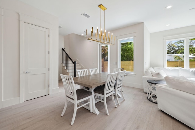 55 May Dr, Santa Rosa Beach, FL 32459 - dining room with a chandelier, light wood finished floors, stairway, baseboards, and recessed lighting
