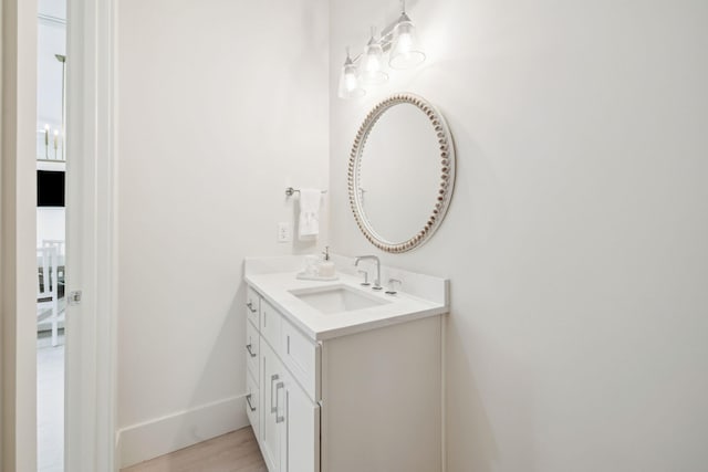 55 May Dr, Santa Rosa Beach, FL 32459 - bathroom featuring double vanity, wood finished floors, and baseboards