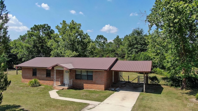 1737 S County Highway 183, Defuniak Springs, FL 32435 - view of front of home with driveway, a carport, brick siding, a front yard, and metal roof