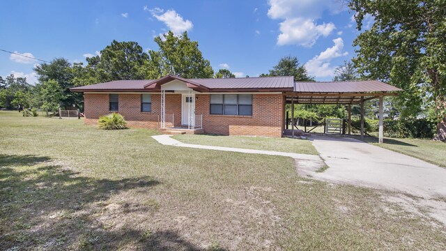 1737 S County Highway 183, Defuniak Springs, FL 32435 - single story home with a front yard, brick siding, a carport, concrete driveway, and metal roof