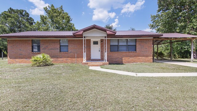 1737 S County Highway 183, Defuniak Springs, FL 32435 - single story home with metal roof, a carport, brick siding, and a front yard