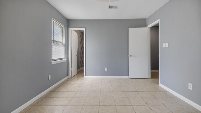 1737 S County Highway 183, Defuniak Springs, FL 32435 - unfurnished bedroom with baseboards and light tile patterned floors