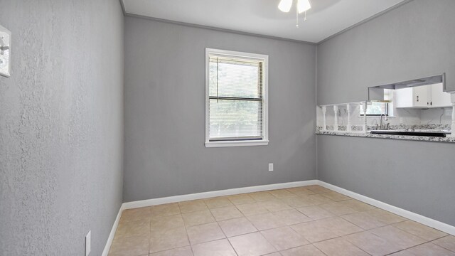 1737 S County Highway 183, Defuniak Springs, FL 32435 - empty room with crown molding, ceiling fan, baseboards, and light tile patterned floors