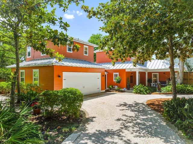 108 S Blue Heron Dr, Santa Rosa Beach, FL 32459 - view of front facade with a standing seam roof, covered porch, metal roof, driveway, and an attached garage