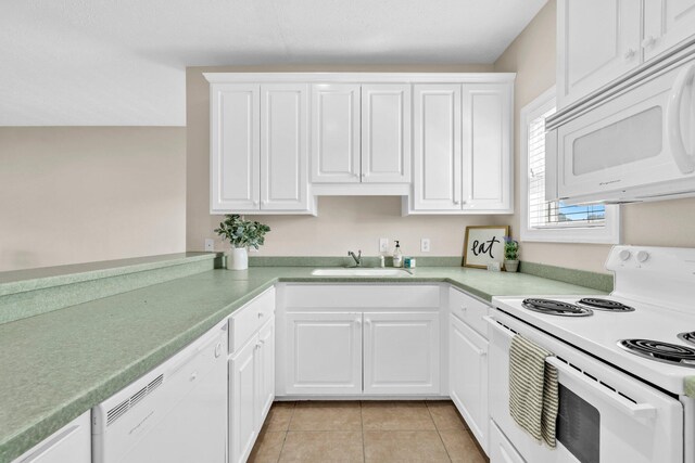 216 Bonita Cir Unit C, Panama City Beach, FL 32408 - kitchen featuring white appliances, a sink, white cabinetry, light tile patterned floors, and light countertops