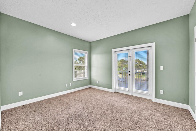 216 Bonita Cir Unit C, Panama City Beach, FL 32408 - unfurnished room featuring baseboards, carpet flooring, healthy amount of natural light, a textured ceiling, and recessed lighting