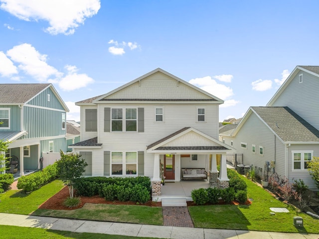3204 Airport Rd, Panama City, FL 32405 - view of front of property featuring a porch, a front yard, and central AC