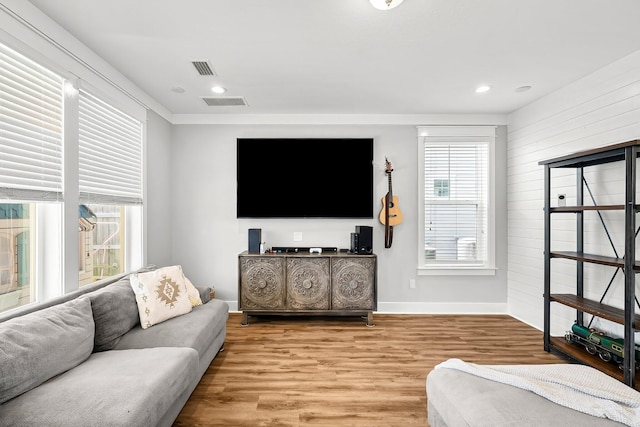 3204 Airport Rd, Panama City, FL 32405 - living area with baseboards, wood finished floors, wooden walls, and recessed lighting