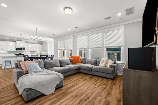3204 Airport Rd, Panama City, FL 32405 - living room featuring a chandelier, wood finished floors, recessed lighting, and crown molding