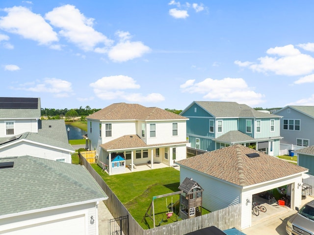 3204 Airport Rd, Panama City, FL 32405 - back of house featuring a residential view, a patio, and a detached garage