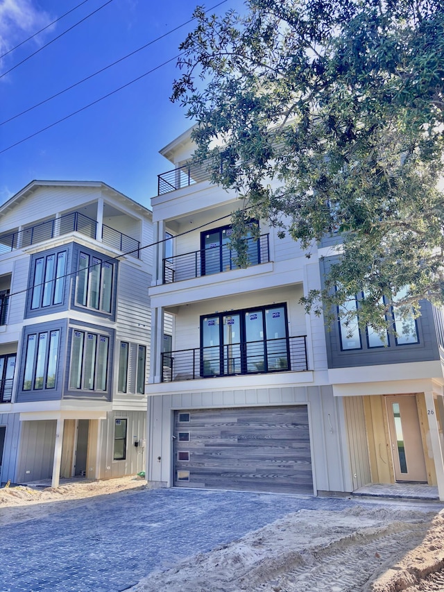3 Mary St, Santa Rosa Beach, FL 32459 - view of front of house featuring board and batten siding, driveway, a garage, and a balcony