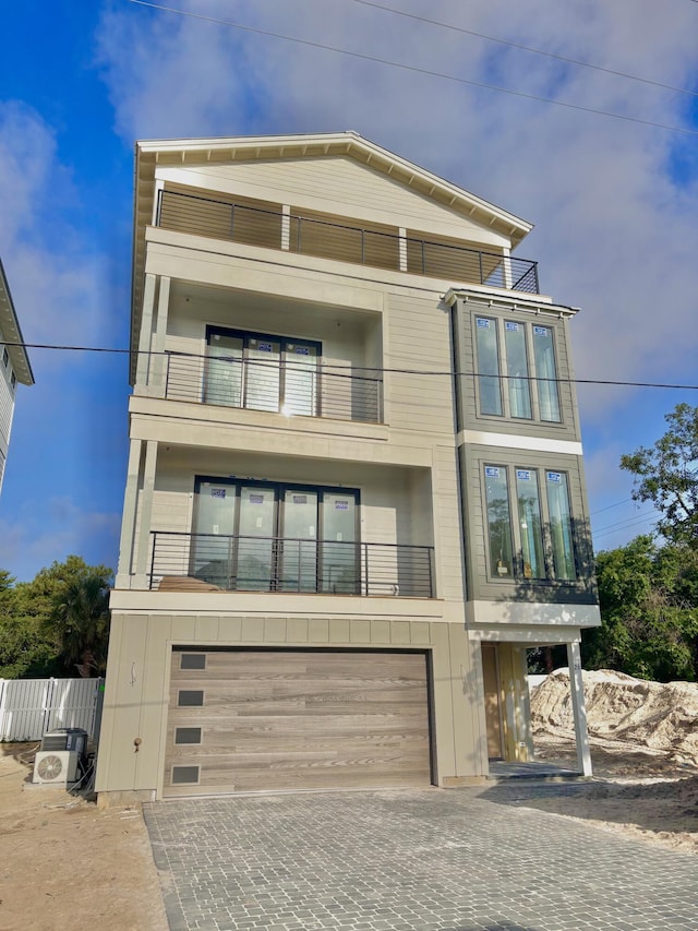 3 Mary St, Santa Rosa Beach, FL 32459 - view of front of house featuring a balcony, an attached garage, and decorative driveway