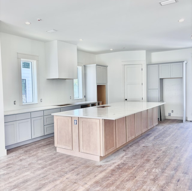 3 Mary St, Santa Rosa Beach, FL 32459 - kitchen featuring light wood finished floors, gray cabinetry, recessed lighting, light countertops, and a large island
