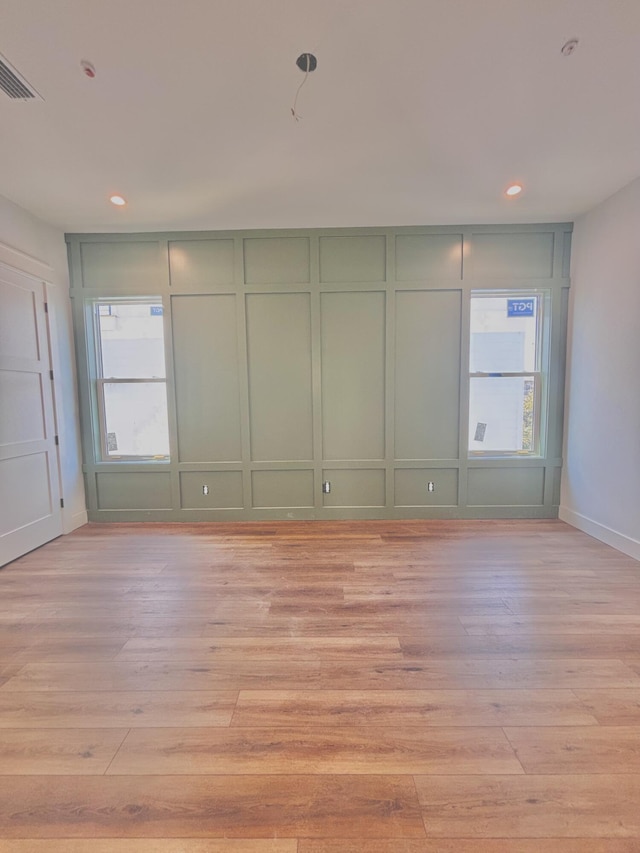 3 Mary St, Santa Rosa Beach, FL 32459 - empty room featuring light wood finished floors, a decorative wall, recessed lighting, and baseboards