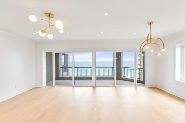 4629 Southwinds Dr Unit 4629, Miramar Beach, FL 32550 - empty room featuring a chandelier, healthy amount of natural light, ornamental molding, light wood-type flooring, and recessed lighting