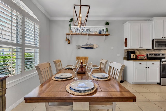 35 Opal Cv, Miramar Beach, FL 32550 - dining area featuring healthy amount of natural light, light tile patterned flooring, crown molding, and baseboards