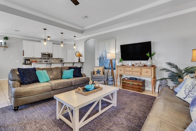 35 Opal Cv, Miramar Beach, FL 32550 - living room with arched walkways, ornamental molding, a ceiling fan, baseboards, and tile patterned flooring