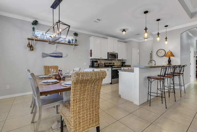 35 Opal Cv, Miramar Beach, FL 32550 - kitchen featuring stainless steel appliances, arched walkways, white cabinetry, a breakfast bar area, and light tile patterned floors