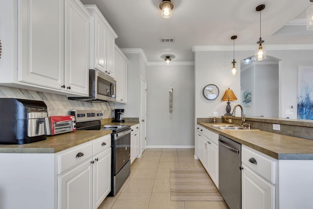 35 Opal Cv, Miramar Beach, FL 32550 - kitchen with stainless steel appliances, a sink, a peninsula, white cabinets, and crown molding