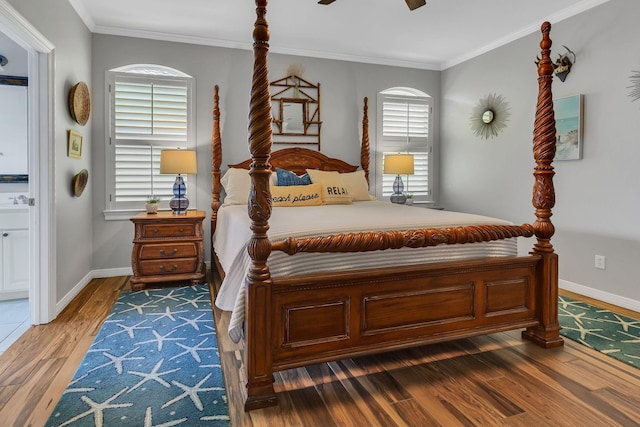35 Opal Cv, Miramar Beach, FL 32550 - bedroom with wood finished floors, baseboards, crown molding, ensuite bathroom, and ceiling fan