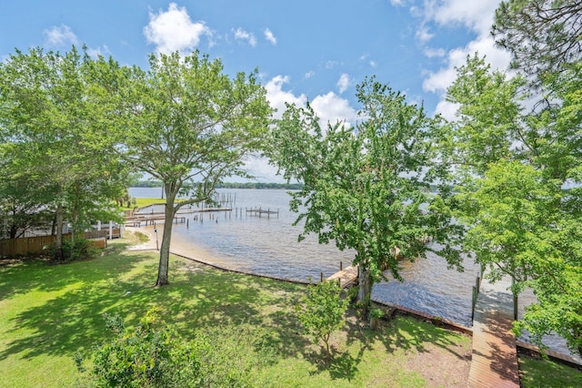 1405 N Bayshore Dr, Niceville, FL 32578 - view of grassy yard with a water view and a boat dock