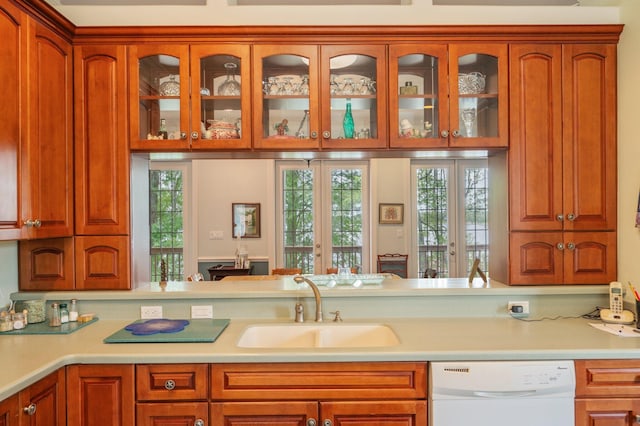 1405 N Bayshore Dr, Niceville, FL 32578 - kitchen with white dishwasher, a sink, light countertops, and glass insert cabinets
