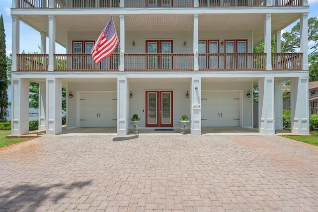 1405 N Bayshore Dr, Niceville, FL 32578 - view of front facade with french doors, a garage, and decorative driveway