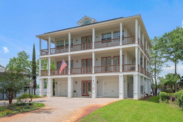 1405 N Bayshore Dr, Niceville, FL 32578 - view of front of property featuring french doors, a balcony, a garage, decorative driveway, and a front lawn