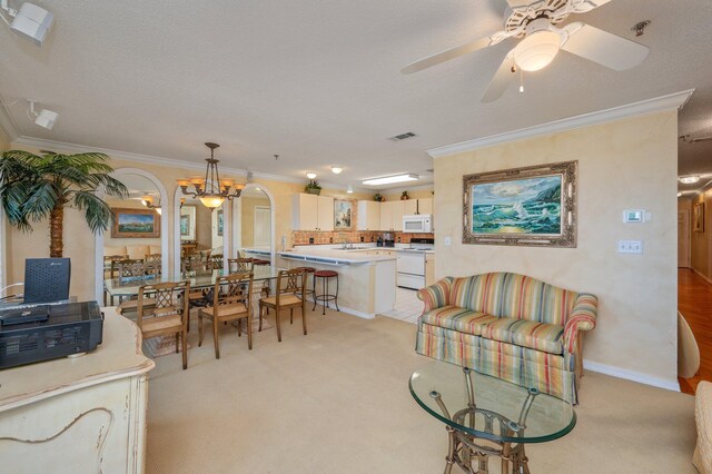 144 Spires Ln Unit 403, Santa Rosa Beach, FL 32459 - dining area with light carpet, crown molding, a ceiling fan, and a textured ceiling