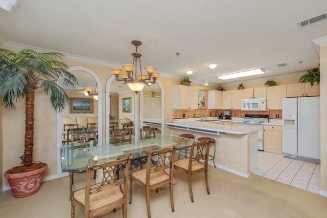 144 Spires Ln Unit 403, Santa Rosa Beach, FL 32459 - dining area featuring crown molding, arched walkways, a chandelier, a textured ceiling, and light carpet