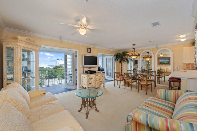 144 Spires Ln Unit 403, Santa Rosa Beach, FL 32459 - living room with light colored carpet, ceiling fan, crown molding, and a chandelier