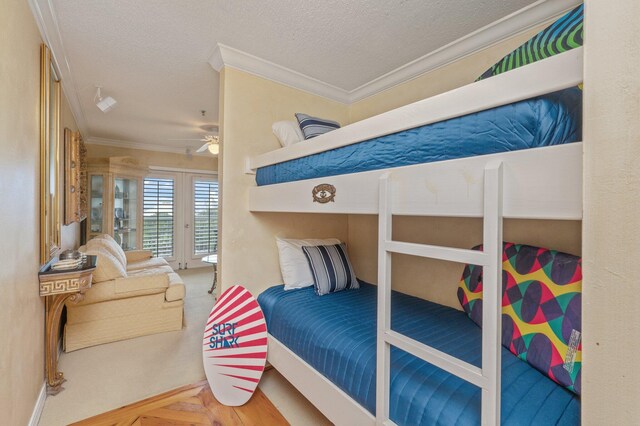 144 Spires Ln Unit 403, Santa Rosa Beach, FL 32459 - bedroom with crown molding, a textured ceiling, and access to exterior