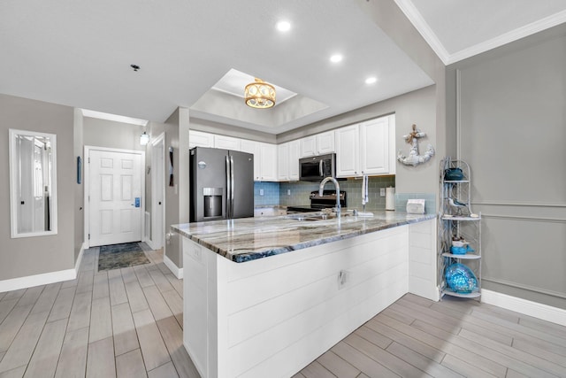 122 Seascape Dr Unit 1104, Miramar Beach, FL 32550 - kitchen featuring stainless steel appliances, a peninsula, wood finish floors, light stone counters, and recessed lighting